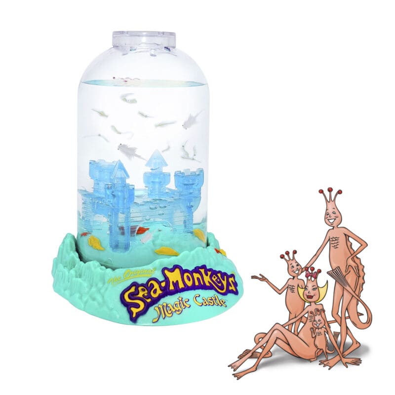 23230-Sea-Monkeys Magic Castle-Image5 The aquarium is out of the package with Sea-Monkeys swimming in the water inside. A family of four illustrated Sea-Monkeys are in front of the product. They are illustrations from the 1970's.
